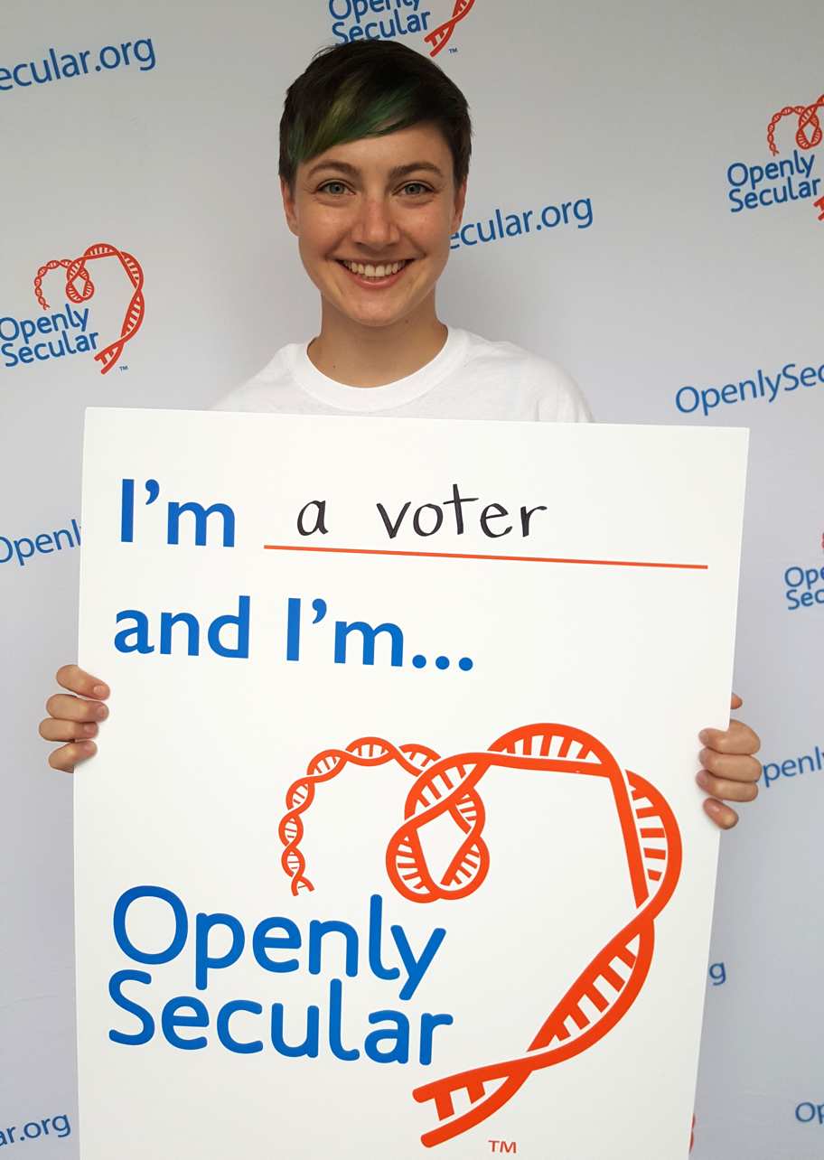 woman holding sign that reads: I'm a voter and I'm Openly Secular